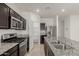 Modern kitchen featuring stainless steel appliances, granite countertops, and dark cabinetry at 3480 N 307Th Dr, Buckeye, AZ 85396