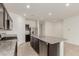 Spacious kitchen with granite countertops, stainless steel appliances, and dark brown cabinetry at 3480 N 307Th Dr, Buckeye, AZ 85396