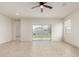 Bright, light-filled living room with tile flooring and sliding glass doors to the backyard at 3480 N 307Th Dr, Buckeye, AZ 85396