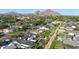 An aerial view of a neighborhood showcases well-kept homes with mountain views and desert landscaping at 3653 E Highland Ave, Phoenix, AZ 85018