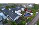 Aerial view showcases a backyard pool, spa, fire pit, lush garden, solar panels, and well-maintained landscaping at 3653 E Highland Ave, Phoenix, AZ 85018