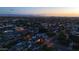 Aerial view shows homes in a neighborhood at twilight; some homes have illuminated pools and yards at 3653 E Highland Ave, Phoenix, AZ 85018