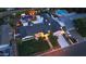 Aerial view featuring the home with a pool, fire pit area, covered patio and a spacious driveway at 3653 E Highland Ave, Phoenix, AZ 85018