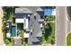 Aerial view of the roof with solar panels, pool, outdoor seating, and lush greenery at 3653 E Highland Ave, Phoenix, AZ 85018