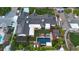 Aerial view of a beautiful home with a backyard featuring a pool, spa, fire pit, lush garden and solar panels at 3653 E Highland Ave, Phoenix, AZ 85018