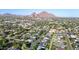 An elevated neighborhood shot with houses surrounded by trees and mountains in the background at 3653 E Highland Ave, Phoenix, AZ 85018