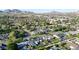 An elevated view of single Gathering homes surrounded by lush trees with mountains in the distance at 3653 E Highland Ave, Phoenix, AZ 85018