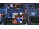 Aerial view of home with pool, spa, fire pit, solar panels, and manicured lawn under soft outdoor lighting at 3653 E Highland Ave, Phoenix, AZ 85018