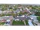 Aerial shot showcasing home with manicured lawn, driveway, mature trees, and neighborhood at 3653 E Highland Ave, Phoenix, AZ 85018