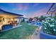 Lush backyard featuring a pool, fire pit, outdoor seating, and manicured landscaping at 3653 E Highland Ave, Phoenix, AZ 85018