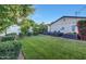 A spacious backyard offers well-manicured lawn with garden beds and an outdoor fire pit area at 3653 E Highland Ave, Phoenix, AZ 85018