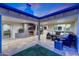 Covered patio featuring a cozy seating area, fireplace, and an expansive view of the backyard at 3653 E Highland Ave, Phoenix, AZ 85018