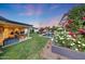 Lush backyard featuring a pool, fire pit, outdoor seating, and manicured landscaping at 3653 E Highland Ave, Phoenix, AZ 85018