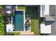 Aerial view of a luxurious backyard featuring a pool, spa, fire pit, and patio area with lush landscaping at 3653 E Highland Ave, Phoenix, AZ 85018