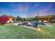 Beautiful backyard featuring a pool with waterfall, fire pit, and inviting outdoor seating at 3653 E Highland Ave, Phoenix, AZ 85018