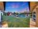 Expansive backyard showcasing a sparkling pool, cozy fire pit, and outdoor lounging areas at 3653 E Highland Ave, Phoenix, AZ 85018