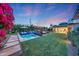 Lush backyard oasis with a pool, spa, and inviting lounge areas for relaxation at 3653 E Highland Ave, Phoenix, AZ 85018