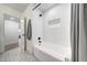 Bright bathroom features white subway tiles, modern fixtures, and patterned floor for a clean aesthetic at 3653 E Highland Ave, Phoenix, AZ 85018