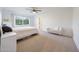 Bright bedroom with a window view, ceiling fan, and cozy seating, offering a relaxing and inviting space at 3653 E Highland Ave, Phoenix, AZ 85018