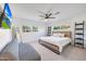 Bright bedroom featuring a ceiling fan, mounted TV, and cozy furniture, creating a peaceful retreat at 3653 E Highland Ave, Phoenix, AZ 85018