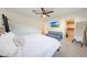A well-lit bedroom with a ceiling fan, cozy seating, and TV offers a relaxing atmosphere at 3653 E Highland Ave, Phoenix, AZ 85018