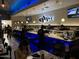 Interior of Sushiholic featuring a sushi bar with blue lighting and TV screens at 3653 E Highland Ave, Phoenix, AZ 85018