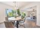 Cozy dining area featuring a modern round table with stylish chairs and views of the landscaped yard at 3653 E Highland Ave, Phoenix, AZ 85018