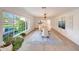 Elegant dining room with a large window, stylish rug, and seating for eight at 3653 E Highland Ave, Phoenix, AZ 85018