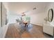 Bright dining room features a large wooden table, pendant lighting, and seamless access to other living spaces at 3653 E Highland Ave, Phoenix, AZ 85018