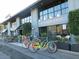 Exterior view of Fox Restaurant Concepts featuring large windows and various bicycles at 3653 E Highland Ave, Phoenix, AZ 85018