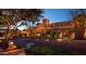 Exterior view of a charming hotel lit up at night with manicured landscaping at 3653 E Highland Ave, Phoenix, AZ 85018
