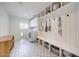 Well-lit laundry room with a front-loading washer and dryer, built-in shelves, and bench with storage at 3653 E Highland Ave, Phoenix, AZ 85018