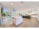 Open-concept living area with hardwood floors, a white sofa, and seamless flow into the modern kitchen at 3653 E Highland Ave, Phoenix, AZ 85018
