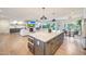 Open-concept living space featuring a modern kitchen island, fireplace, and ample natural light at 3653 E Highland Ave, Phoenix, AZ 85018