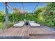 Relaxing outdoor lounge area with overhead trellis, string lights, and lush greenery at 3653 E Highland Ave, Phoenix, AZ 85018