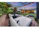Comfortable outdoor living area with daybeds, pergola, and serene backyard views at 3653 E Highland Ave, Phoenix, AZ 85018