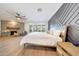 Spacious bedroom with wood flooring, modern fireplace, decorative wood wall, and access to the backyard at 3653 E Highland Ave, Phoenix, AZ 85018