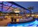 Upscale outdoor bar area with modern lighting and seating by a decorative water feature at 3653 E Highland Ave, Phoenix, AZ 85018