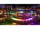 An aerial view of an outdoor gathering space with colorful lights, seating, and palm trees at 3653 E Highland Ave, Phoenix, AZ 85018