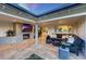 Outdoor patio with fireplace, television, comfortable seating, and direct access to the interior living spaces at 3653 E Highland Ave, Phoenix, AZ 85018