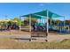 Vibrant playground featuring slides, climbing structures, and a shaded area under a clear blue sky at 3653 E Highland Ave, Phoenix, AZ 85018