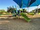 A community playground with slides and climbing equipment under a blue shade structure at 3653 E Highland Ave, Phoenix, AZ 85018