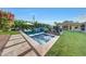 Beautiful backyard pool and spa surrounded by lush greenery, creating a private oasis at 3653 E Highland Ave, Phoenix, AZ 85018