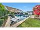 Beautiful backyard oasis featuring a pool, lounge chairs, and lush landscaping at 3653 E Highland Ave, Phoenix, AZ 85018
