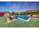 Inviting backyard with a sparkling pool, fire pit, and lounge areas perfect for entertaining at 3653 E Highland Ave, Phoenix, AZ 85018