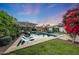 Inviting pool and backyard setting with well-manicured lawn and lush landscaping at 3653 E Highland Ave, Phoenix, AZ 85018