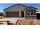 Charming single-story home with a well-manicured lawn and inviting front entrance at 40030 W Agave Rd, Maricopa, AZ 85138