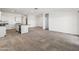 Spacious living area with an open kitchen and stainless steel appliances at 40030 W Agave Rd, Maricopa, AZ 85138
