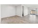 Open-concept living room with sliding door access and tile flooring at 40030 W Agave Rd, Maricopa, AZ 85138