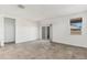 Bright living room featuring recessed lighting, tile floors, and sliding glass door at 40030 W Agave Rd, Maricopa, AZ 85138
